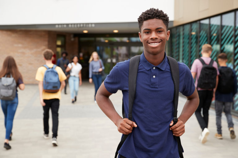 Black High School senior smiling on campus